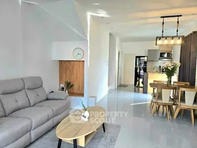 Modern open-plan living room with stylish furniture and dining area