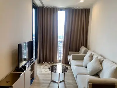 Modern living room with cozy sofa and large window offering city view