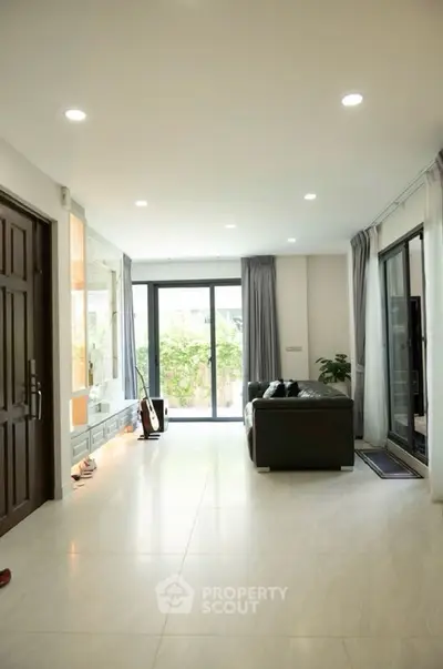 Spacious living room with modern decor and large windows for natural light.