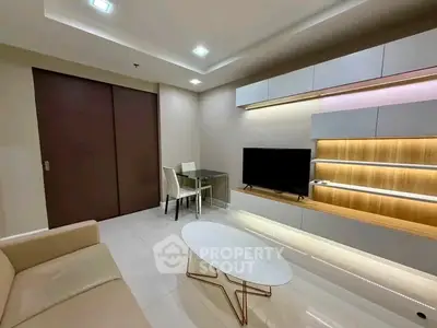 Modern living room with sleek furniture and built-in TV unit, perfect for urban living.