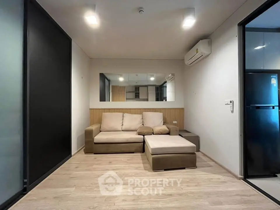 Modern living room with cozy sofa and sleek air conditioning unit, perfect for relaxation and comfort.
