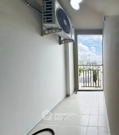 Spacious balcony with city view and air conditioning unit, perfect for relaxation.