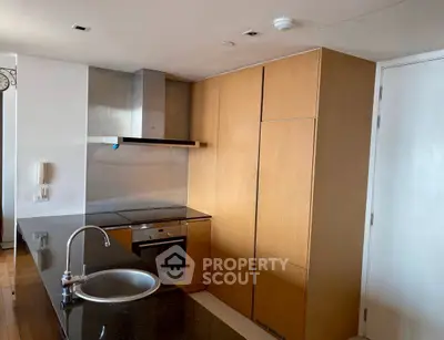 Modern kitchen with sleek wooden cabinets and stainless steel appliances