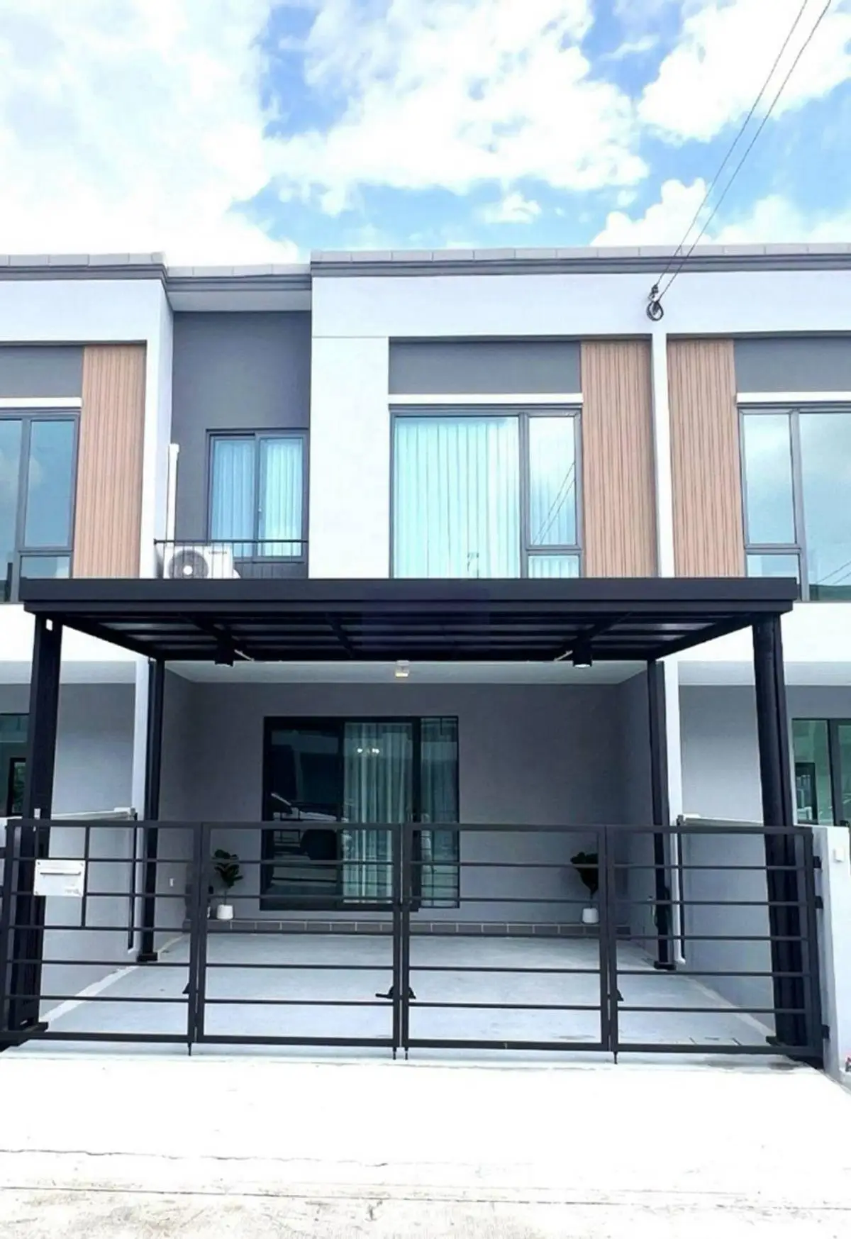 Modern townhouse exterior with sleek design and spacious driveway
