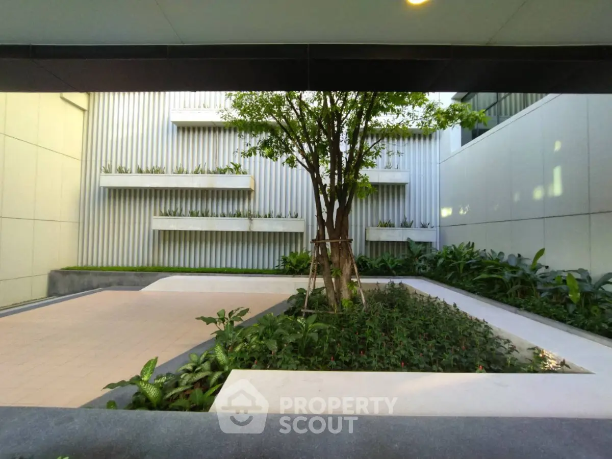 Modern building courtyard with lush greenery and sleek design elements