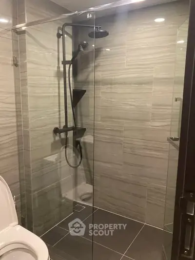 Modern bathroom with glass shower enclosure and sleek tile design