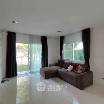 Spacious living room with large windows and modern sectional sofa