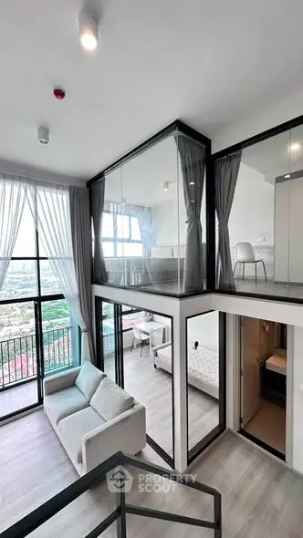 Modern duplex apartment with floor-to-ceiling windows and a stunning city view.