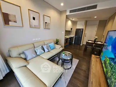 Modern living room with elegant decor and open kitchen layout in a stylish apartment.