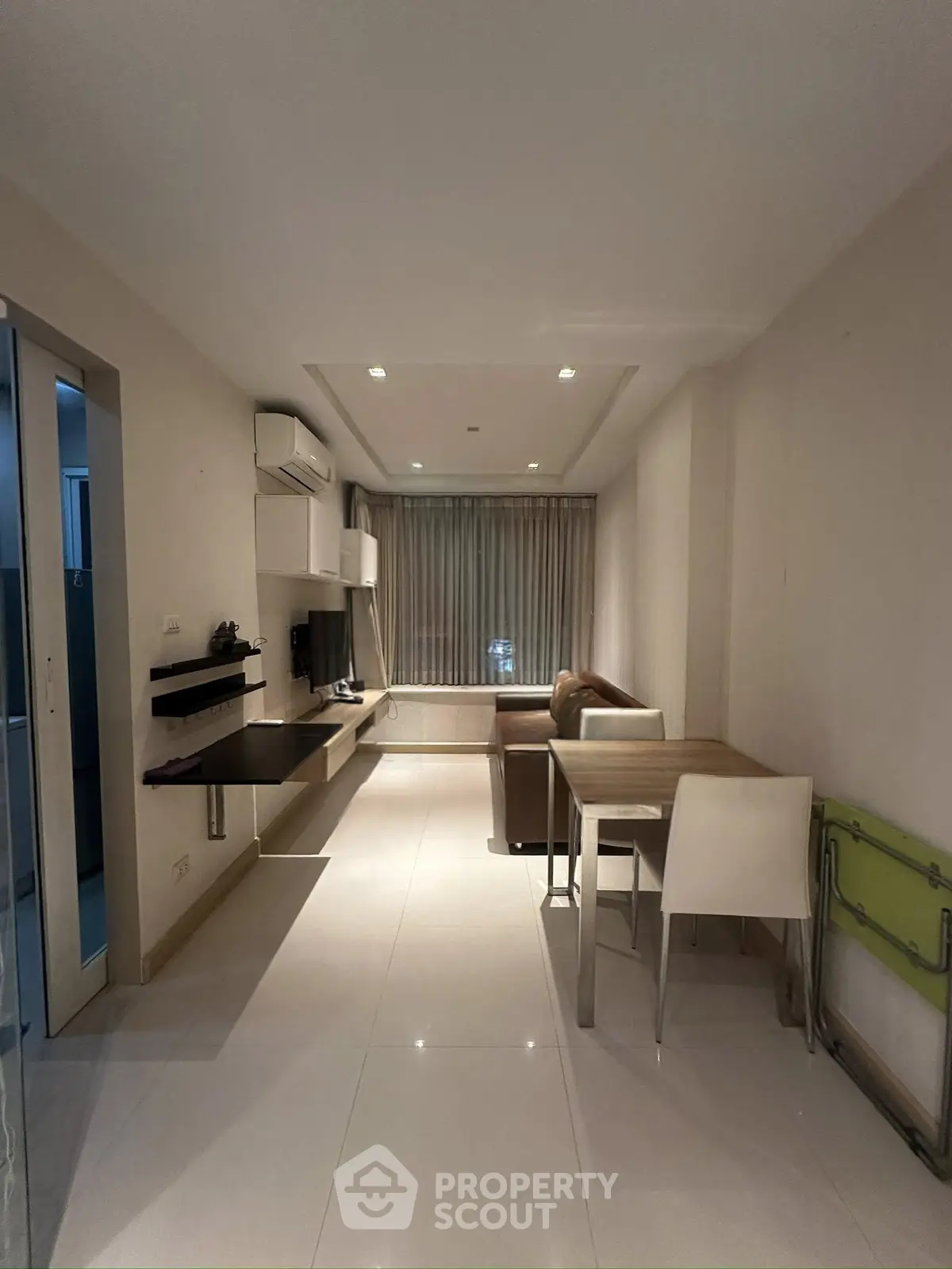 Modern living room with sleek furniture and natural light, perfect for urban living.