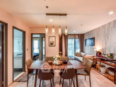 Spacious open-plan living and dining area with modern decor and ambient lighting.