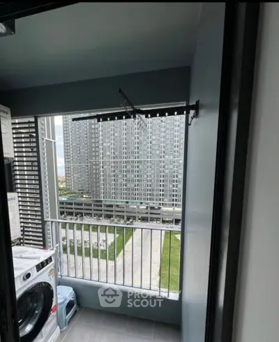 Modern apartment balcony with washing machine and city view