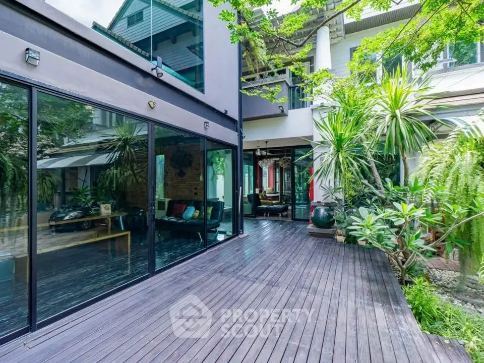Stunning modern home with expansive deck and lush garden, perfect for outdoor living.