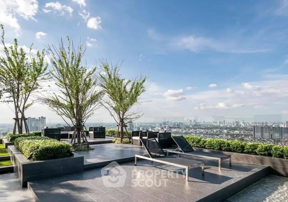 Luxurious rooftop terrace with stunning city skyline view and modern lounge chairs.