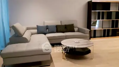 Spacious modern living room with stylish sectional sofa and elegant coffee table.