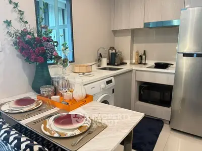 Modern kitchen with sleek appliances and elegant dining setup