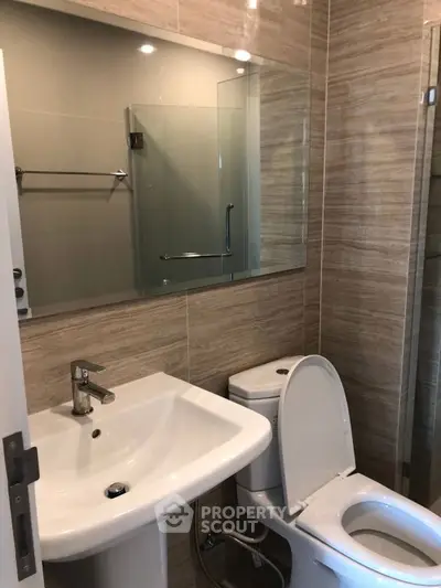 Modern bathroom with sleek fixtures and elegant tile design.