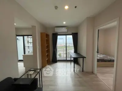 Modern apartment with open layout, large windows, and balcony offering stunning city views.