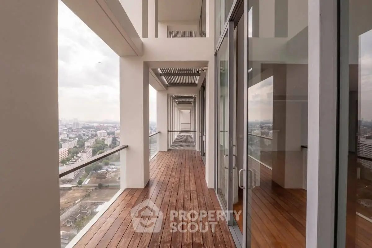 Stunning high-rise balcony with panoramic city views and elegant wooden flooring.