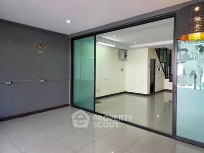 Spacious modern interior with glass sliding doors and sleek tiled flooring