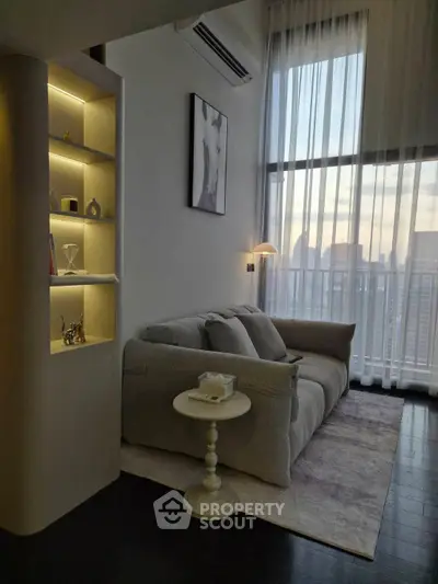 Stylish living room with cozy sofa and city view through large windows