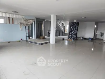 Spacious open-plan interior with modern design and elevator access, ideal for customization.