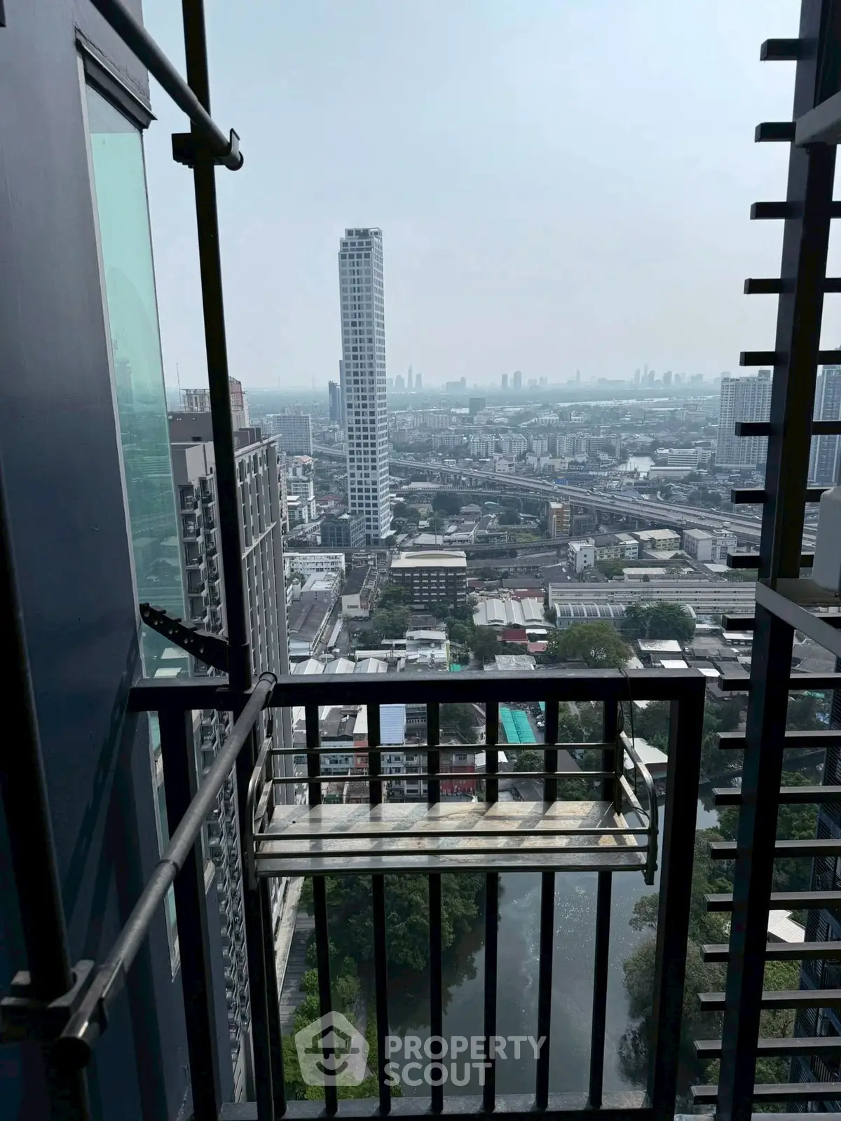 Stunning high-rise balcony view overlooking cityscape and river