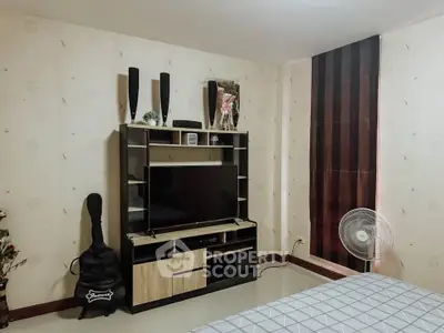 Cozy bedroom with modern entertainment unit and stylish decor