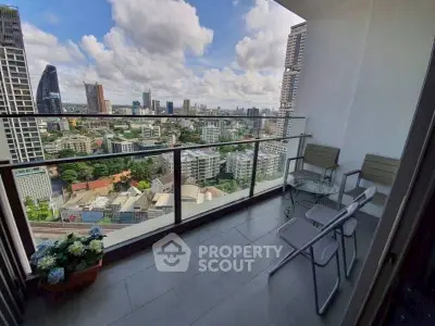 Stunning high-rise balcony with panoramic city views and cozy seating area.