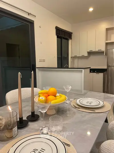 Modern dining area with elegant table setting and open kitchen layout