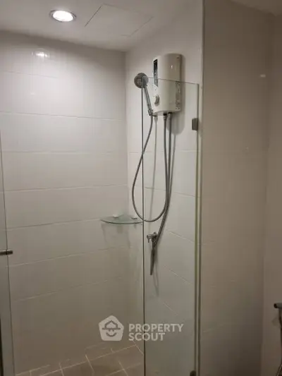 Modern bathroom with sleek shower design and glass partition in a contemporary home.