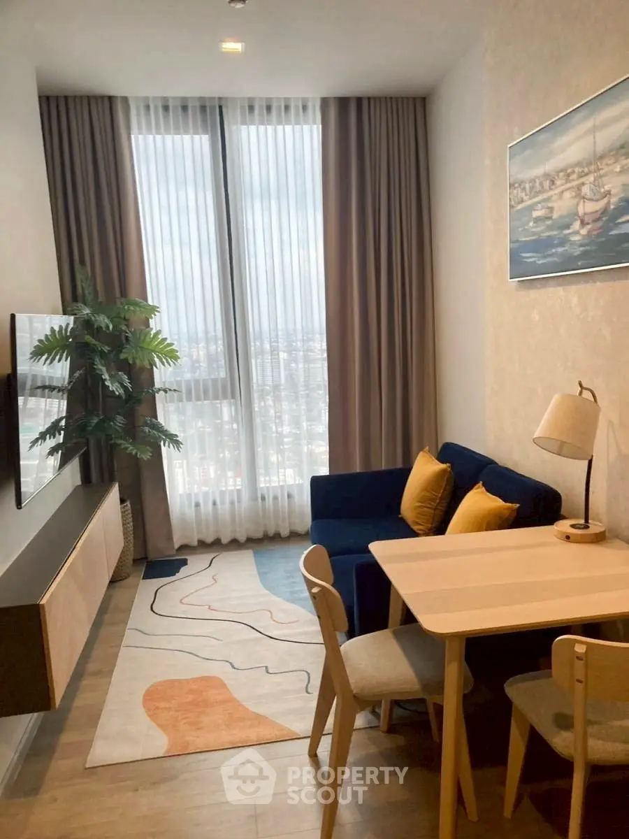 Chic modern living room with city view, stylish furniture, and elegant decor.