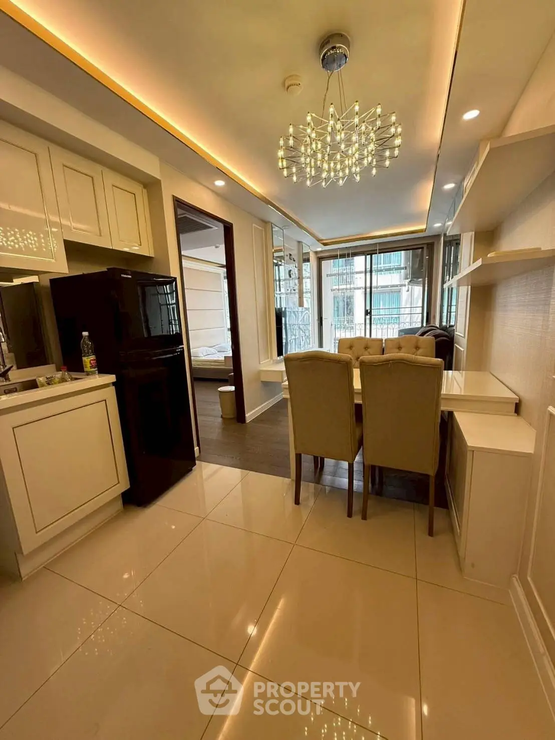 Modern open-plan kitchen and dining area with elegant lighting and sleek design.