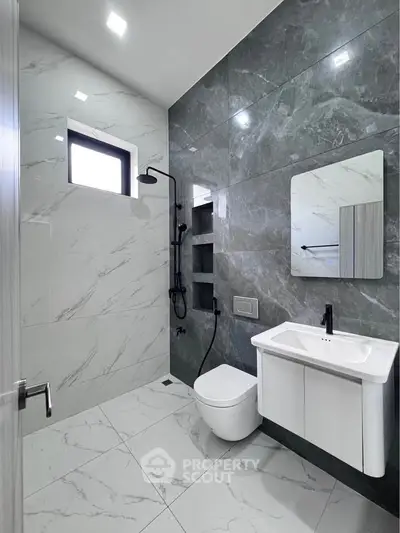 Modern bathroom with sleek marble tiles and minimalist fixtures