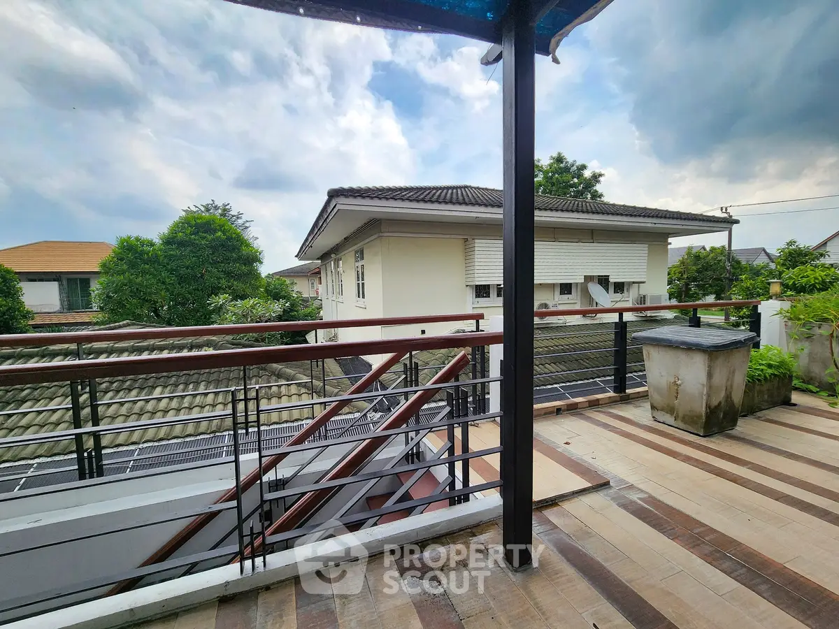 Spacious rooftop terrace with scenic view of suburban neighborhood and lush greenery.