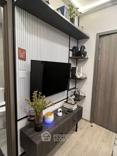 Modern living room with sleek TV setup and stylish shelving