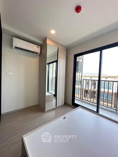 Modern bedroom with large windows and balcony access in a stylish apartment