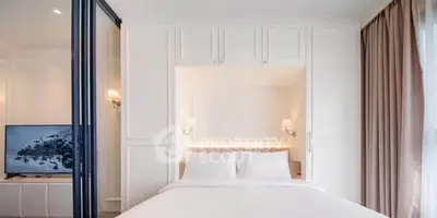 Modern bedroom with built-in storage and elegant lighting in a stylish apartment.