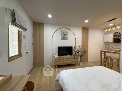 Modern studio apartment with stylish decor and open kitchen layout