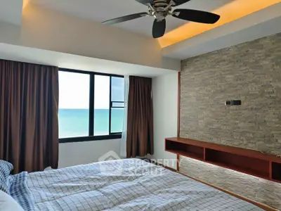 Luxurious bedroom with ocean view and modern stone accent wall