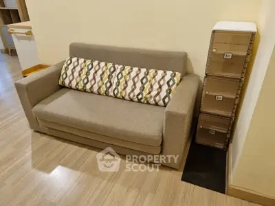 Cozy living room with modern sofa and stylish storage solution, perfect for urban living.