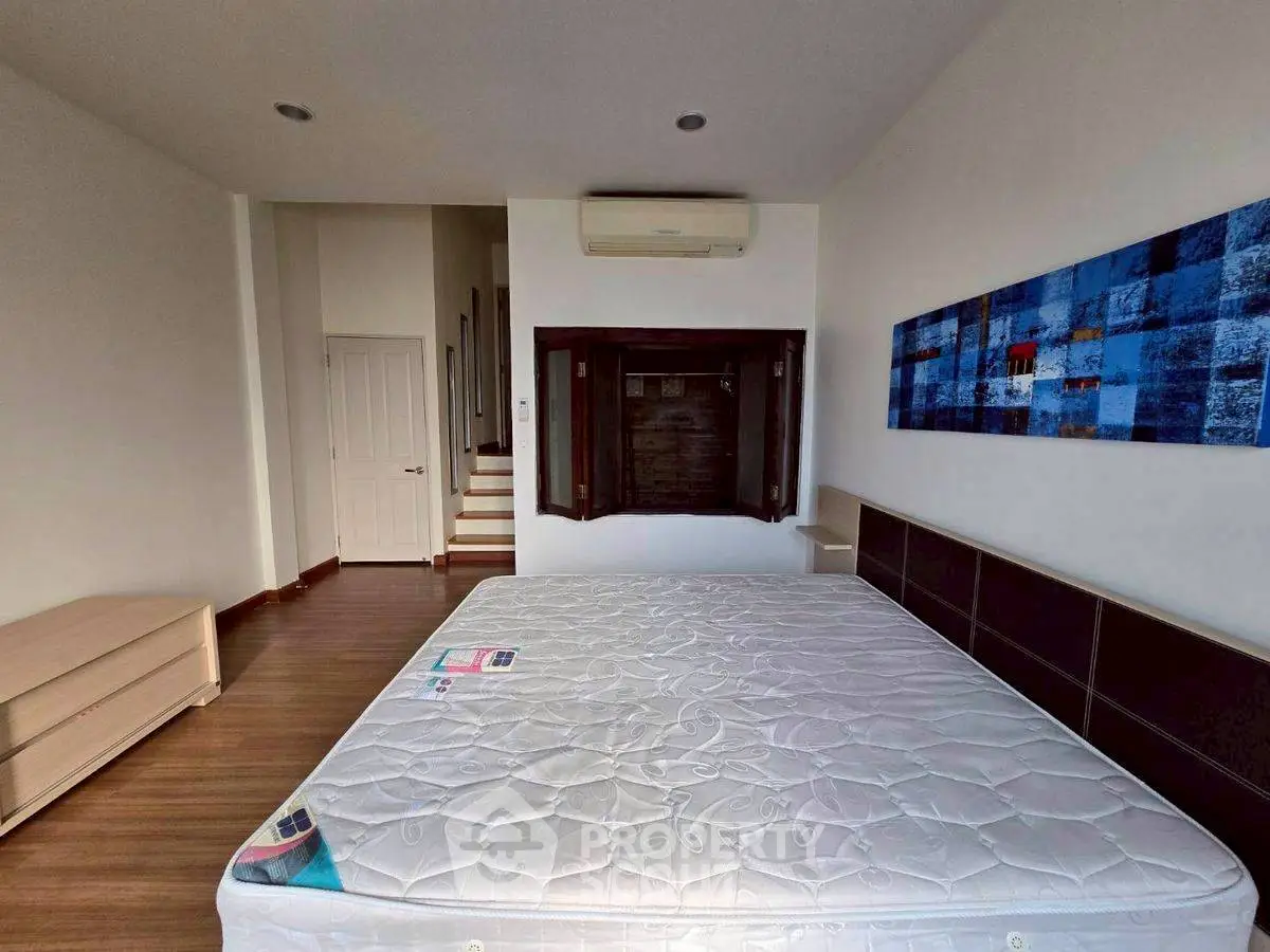 Spacious bedroom with modern decor and air conditioning