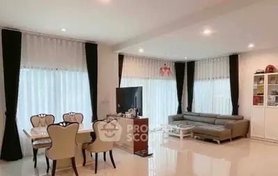 Spacious modern living room with elegant dining area and large windows.