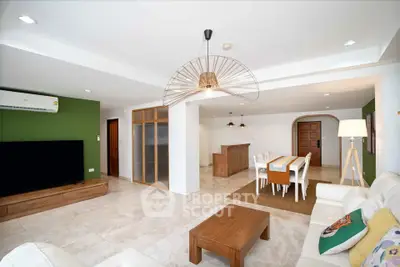 Spacious modern living room with dining area, featuring stylish decor and ample natural light.
