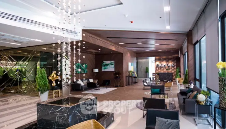 Luxurious modern lobby with elegant decor and stylish seating in a high-end building.