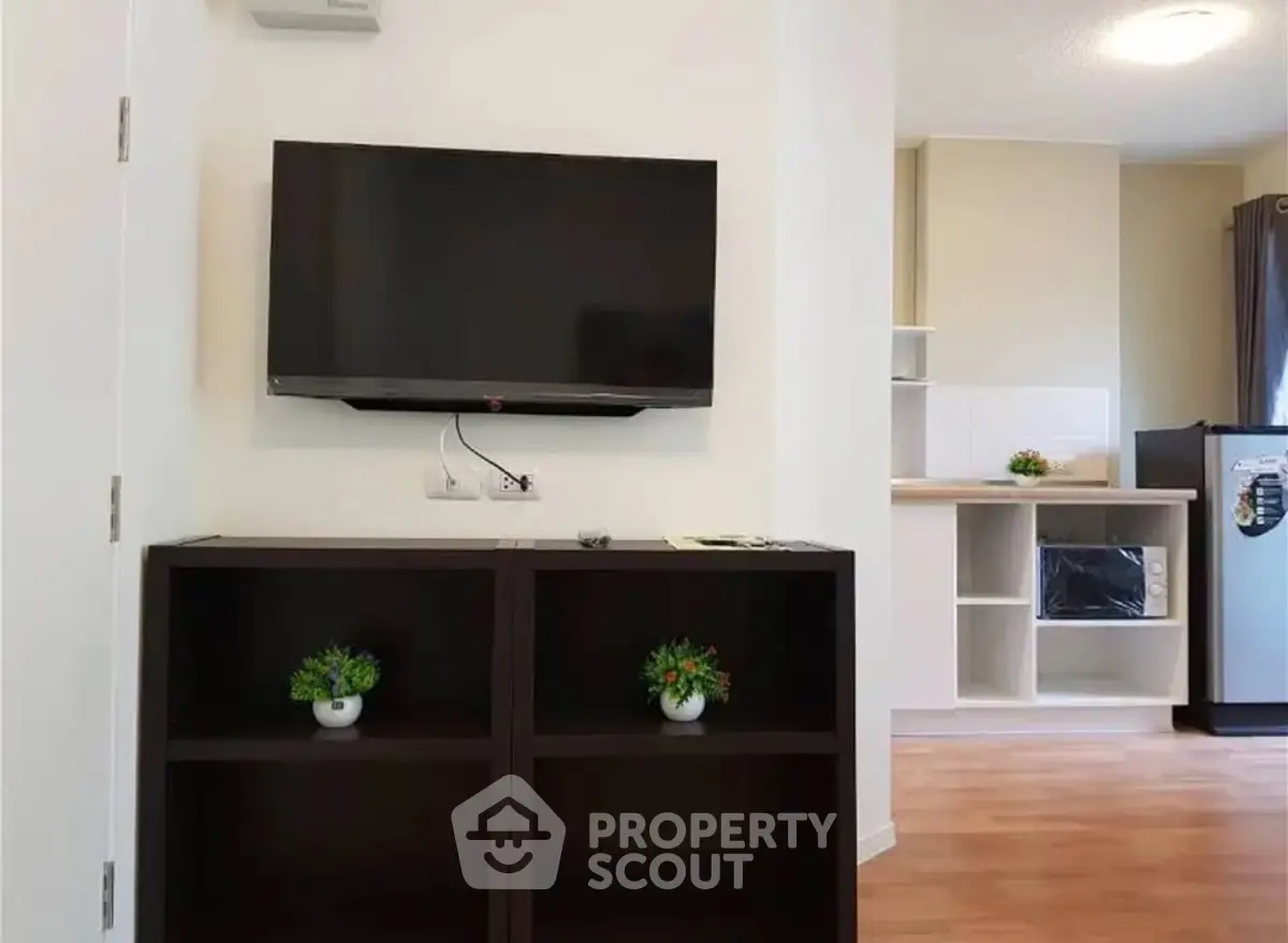 Modern living room with wall-mounted TV and stylish shelving unit