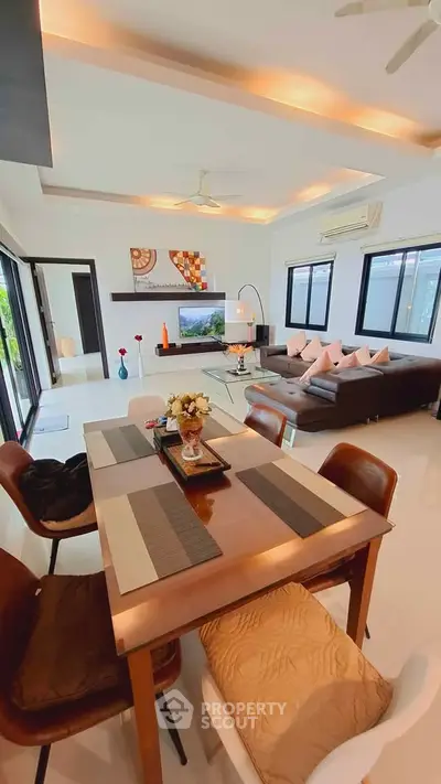 Spacious modern living room with elegant dining area and stylish decor