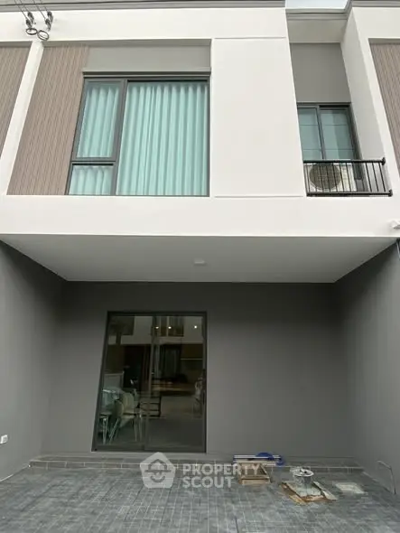 Modern townhouse exterior with large windows and sleek design
