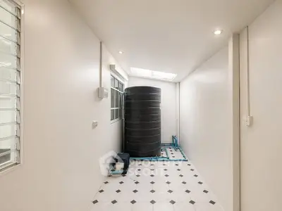 Spacious utility area with water tank and modern tiled flooring