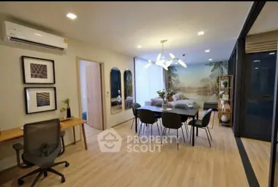 Modern living room with dining area and stylish decor in a contemporary apartment.